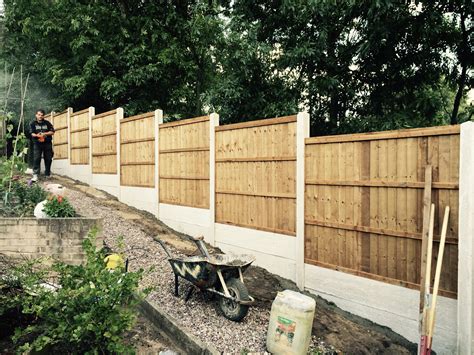 fitting fence posts near house